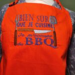 Tablier de cuisine orange "bien sûr que je cuisine, je m'occupe du BBQ"